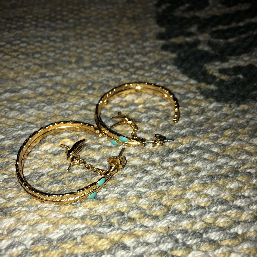 Gold hoop earrings with dangling hummingbird